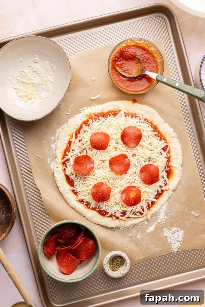 The pepperoni cottage cheese pizza on a piece of parchment paper.