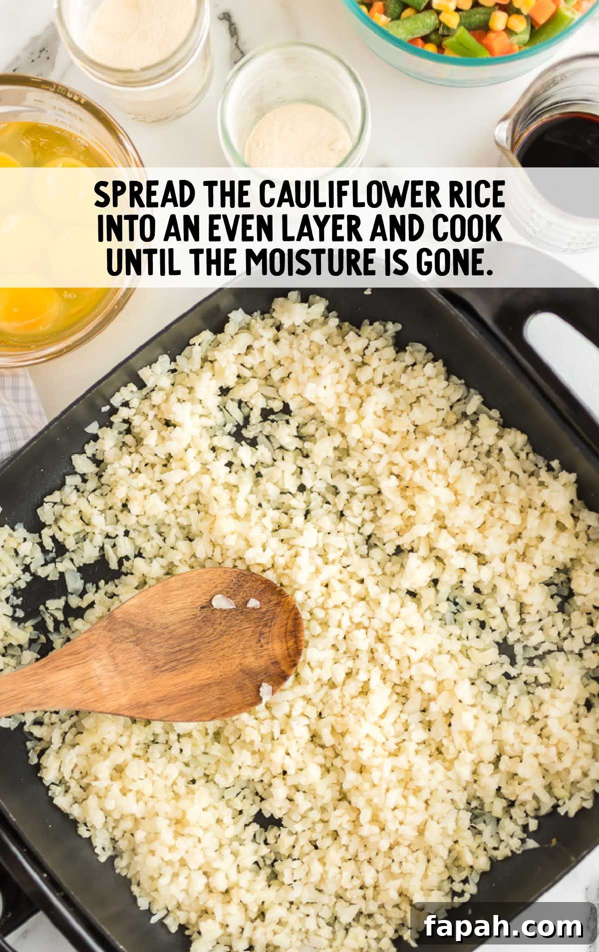 Low-Carb Cauliflower Fried Rice Recipe for Quick Weeknight Meals 3 cauliflower rice being cooked in a skillet