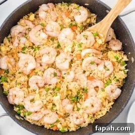 Low-Carb Cauliflower Fried Rice Recipe for Quick Weeknight Meals 6 overhead shot of a skillet of Shrimp Fried Rice garnished with green onions