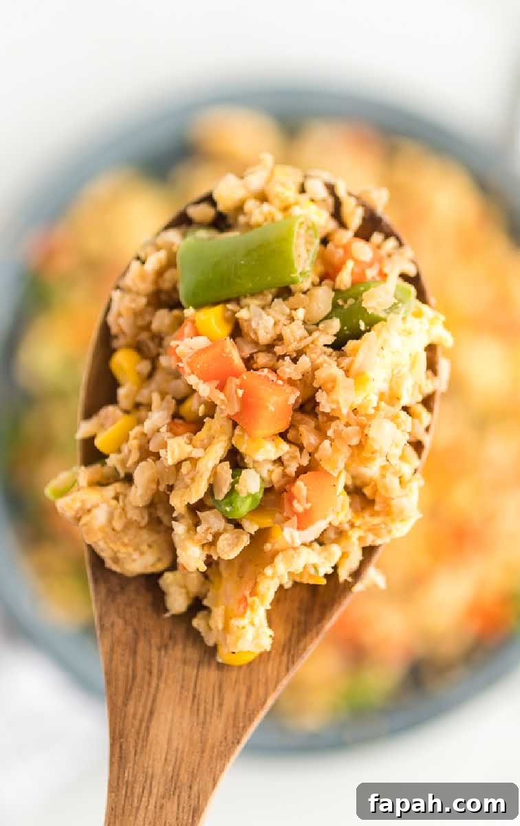 Low-Carb Cauliflower Fried Rice Recipe for Quick Weeknight Meals 8 close up overhead shot of a spoonful of Cauliflower Fried Rice