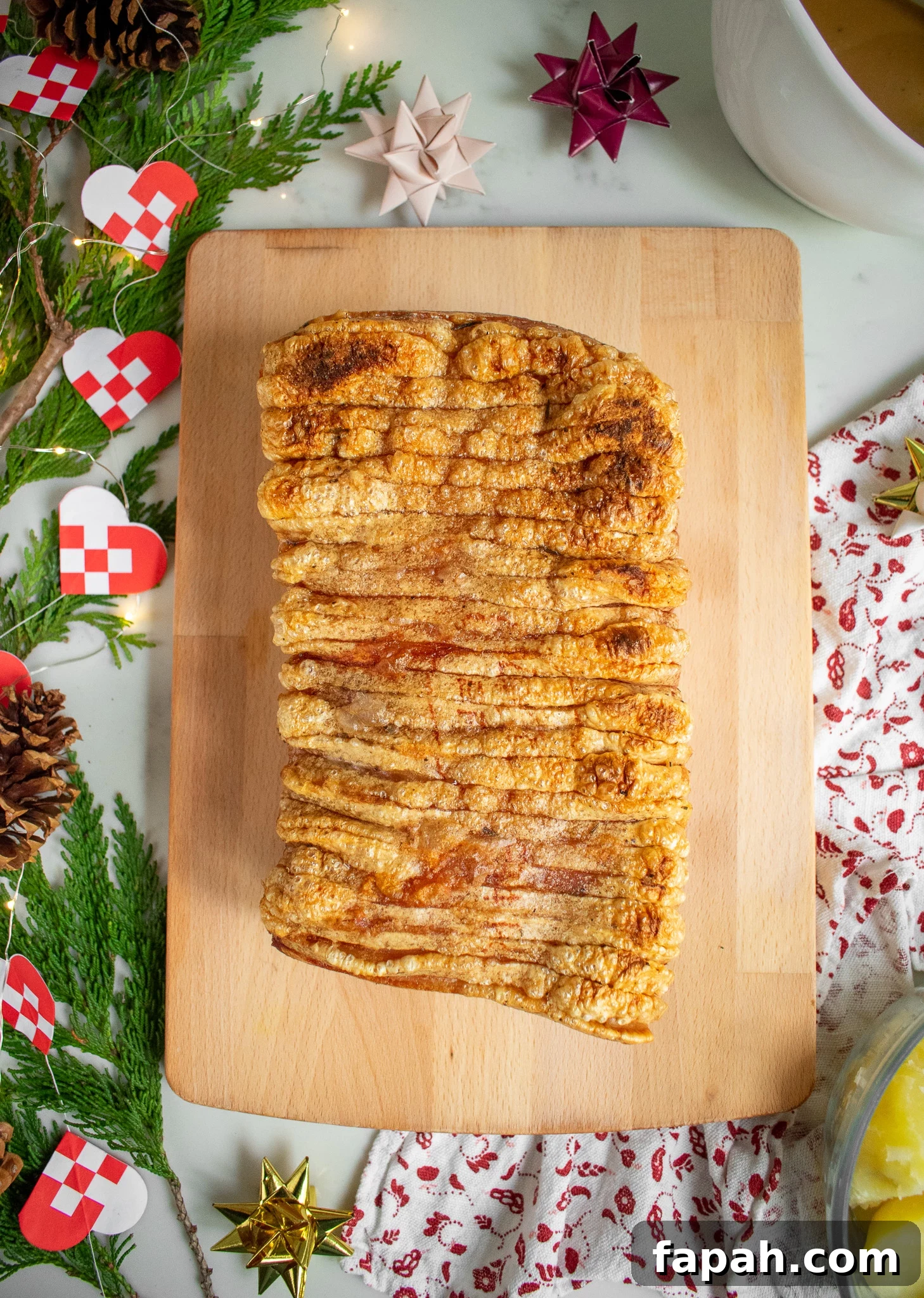 A roast pork loin with crackling on a cutting board.
