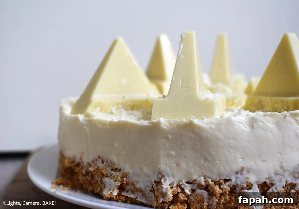 Side view of half of a White Chocolate Toblerone Cheesecake with a white background.