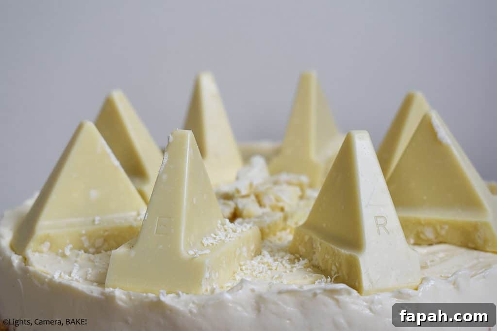 Pieces of toberlone on top of a white chocolate cheesecake with a white background.