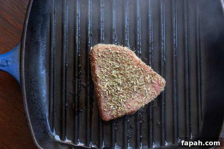 Tuna steak placed on a hot grill pan for one minute on each side. 
