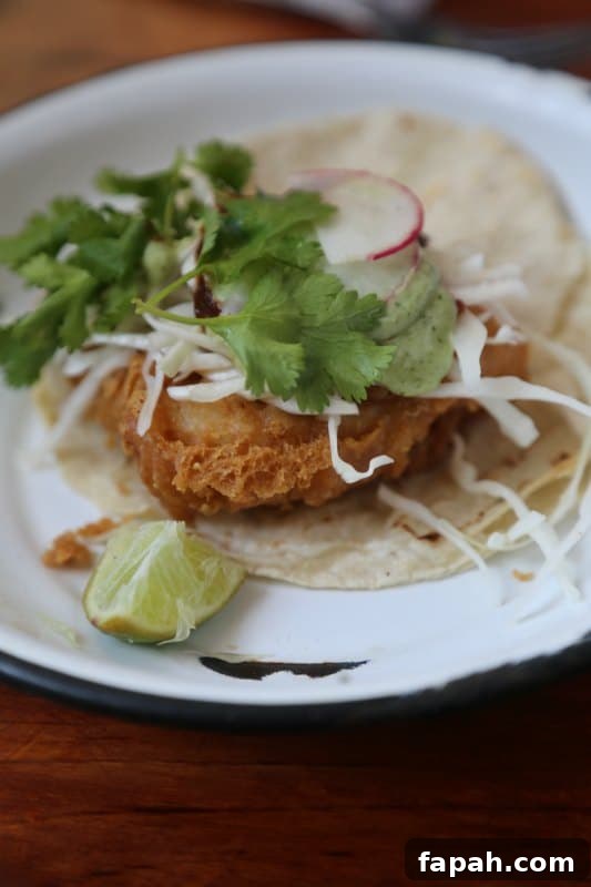 taco on a white plate with a lime slice