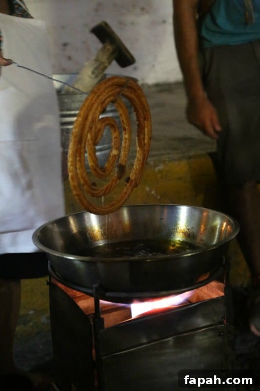 Fresh churros being lifted out of the oil 