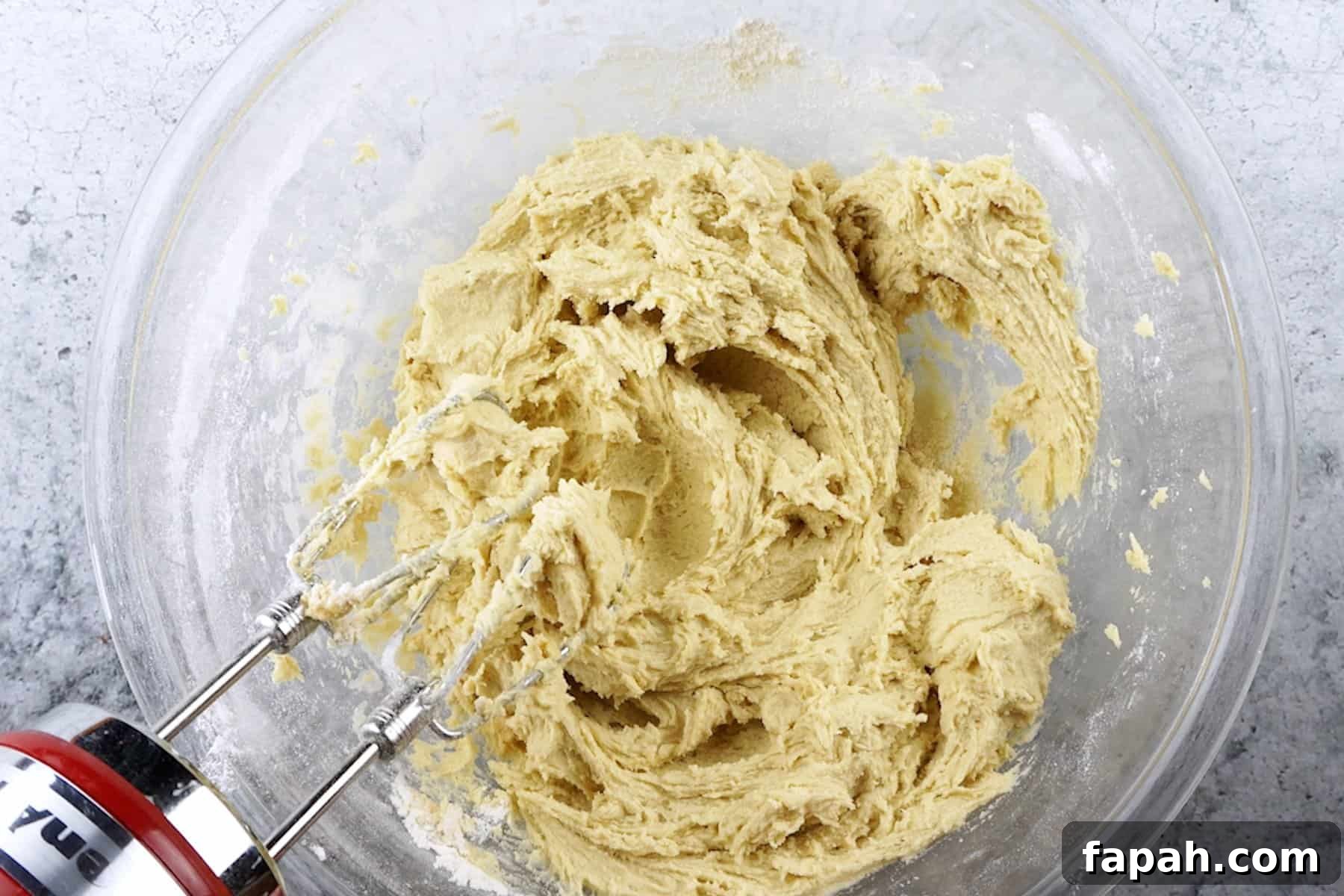Heart-Shaped Cookies Recipe for Valentine’s Day 5 creamed dry and wet ingredients in glass bowl.