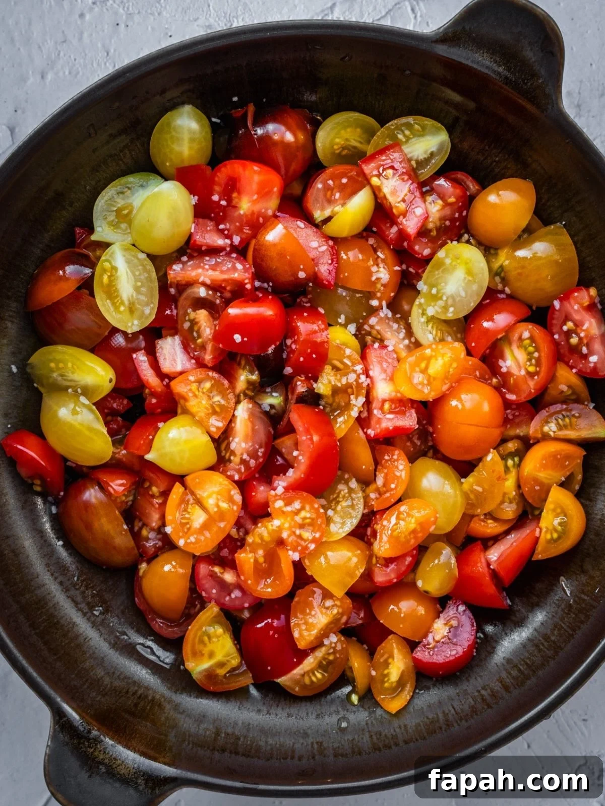 Fresh Cherry Tomato Pico de Gallo Salsa Recipe 4 Sliced cherry tomatoes in a bowl with salt.