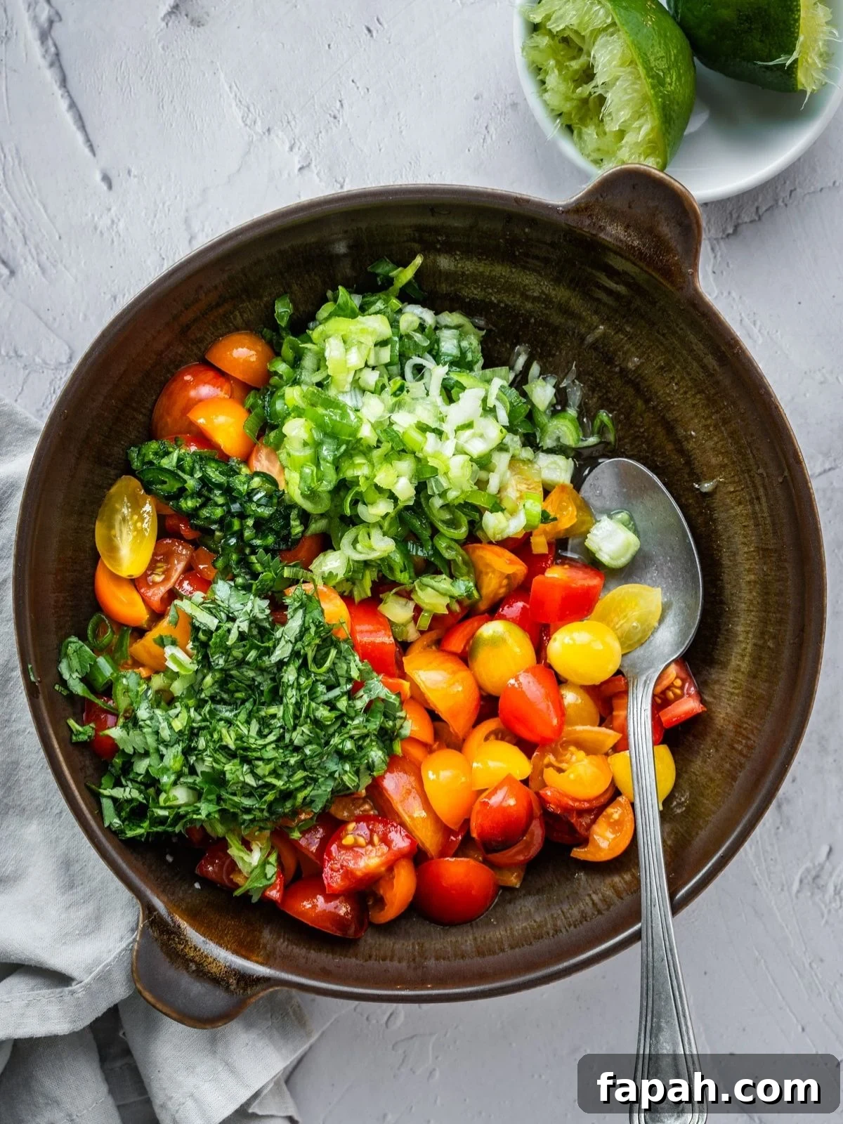 Fresh Cherry Tomato Pico de Gallo Salsa Recipe 6 A bowl of sliced cherry tomatoes, green onions, cilantro, jalapeno and lime.