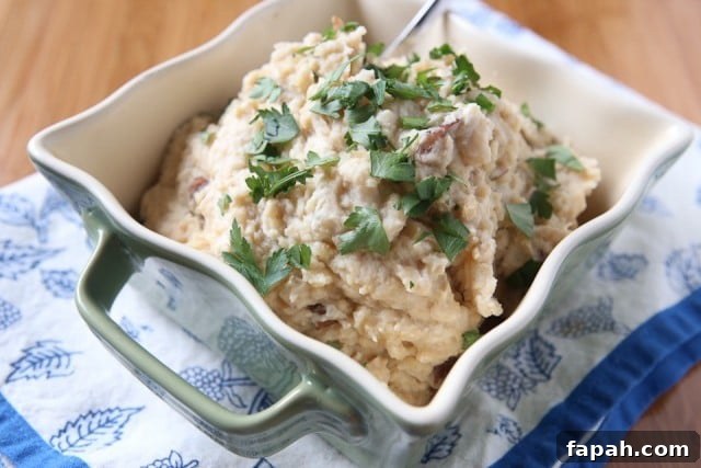 Add these light and creamy Slow Cooker Mashed Potatoes (with cauliflower & Greek yogurt) to your holiday menu. A family favorite recipe from Produce For Kids!