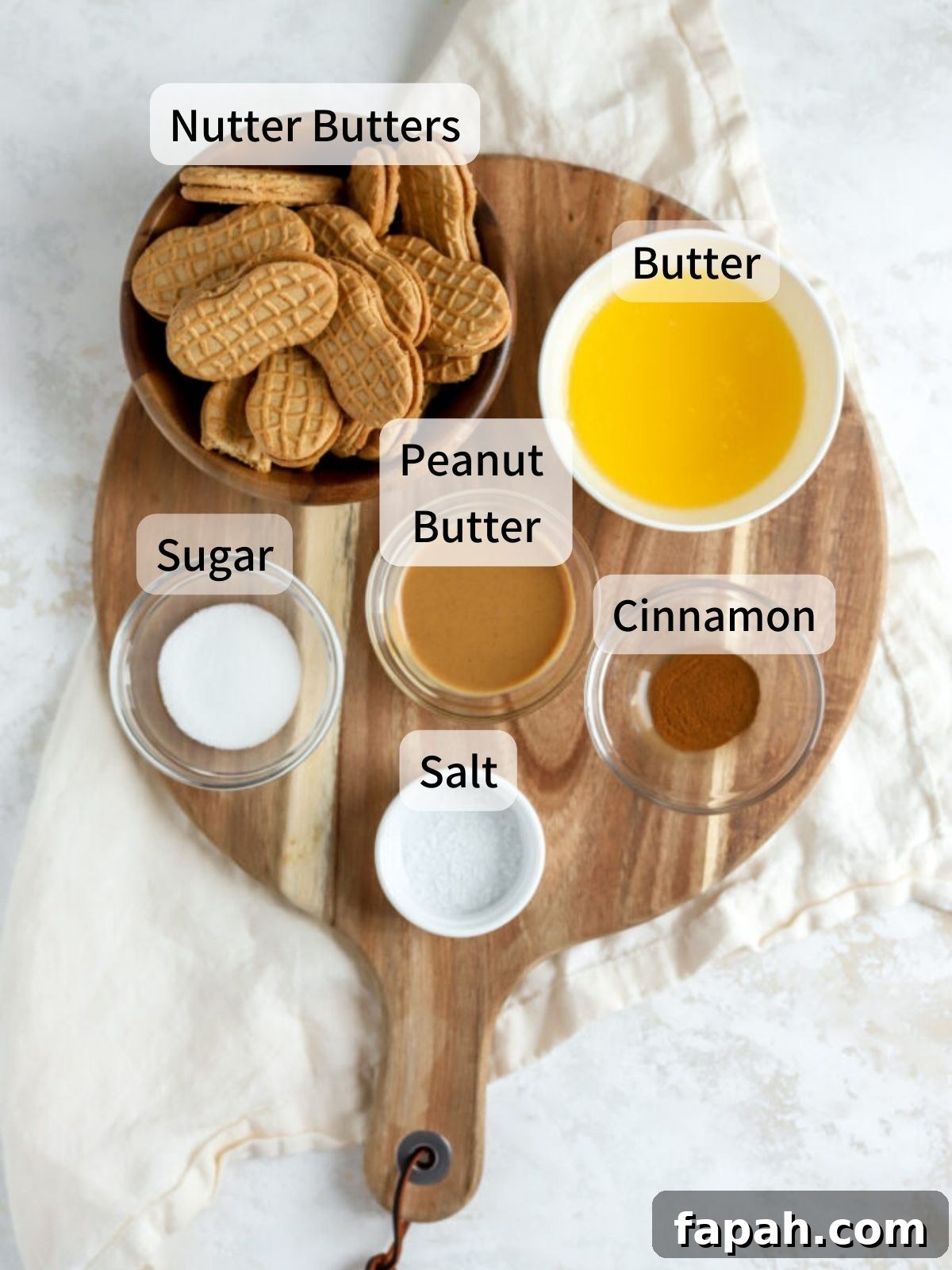 Labeled ingredients needed to make a Nutter Butter crust laid out on a table.
