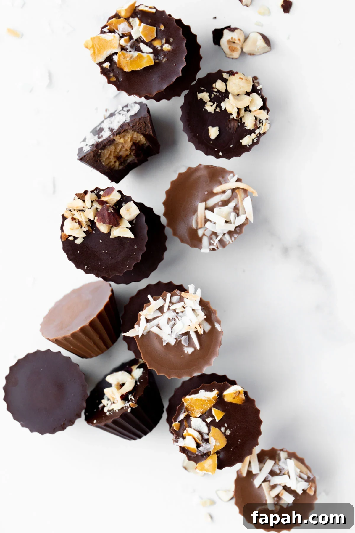 Mini Homemade Peanut Butter Cups: Simple No-Bake Recipe 2 overhead photo of mini peanut butter cups topped with crushed pretzels, toasted coconut, and macadamia nuts