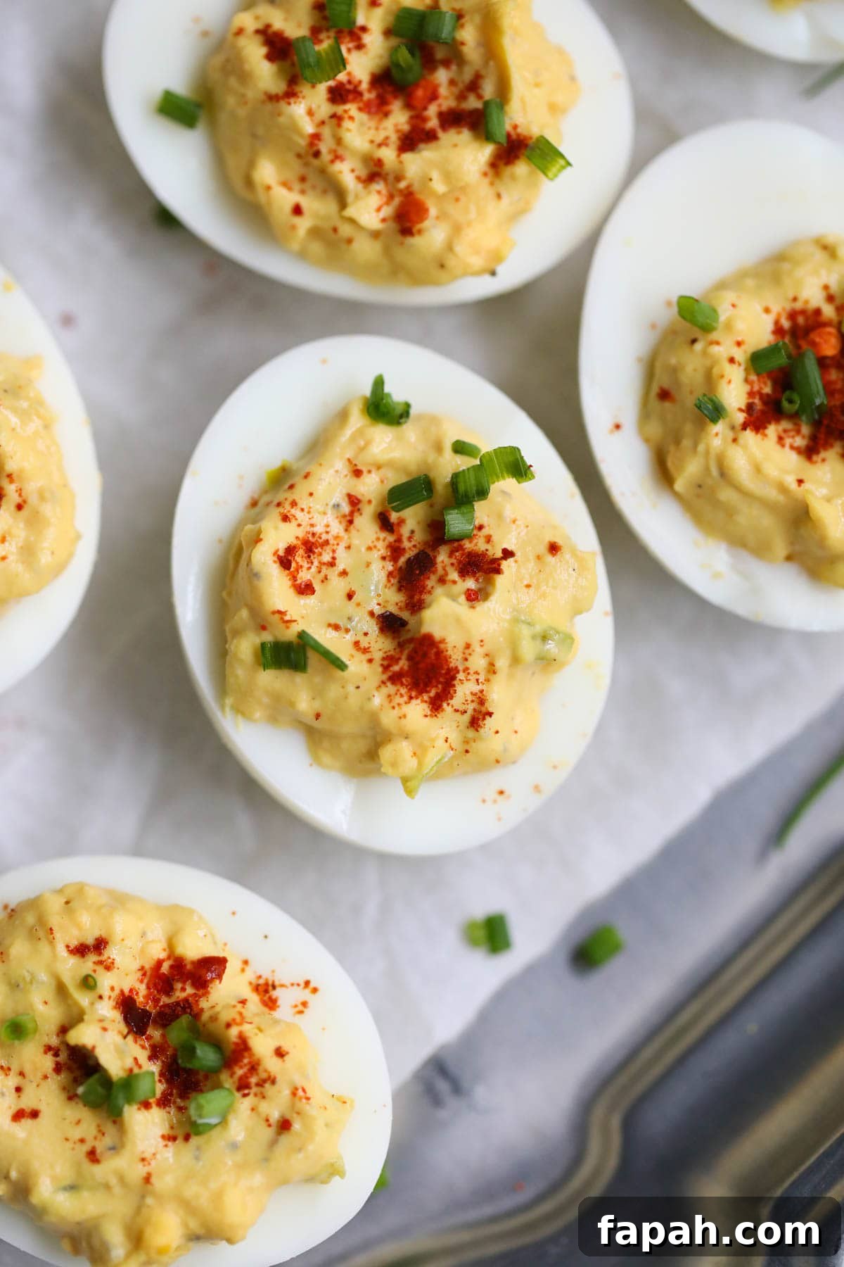 Southern deviled eggs arranged on a silver platter.