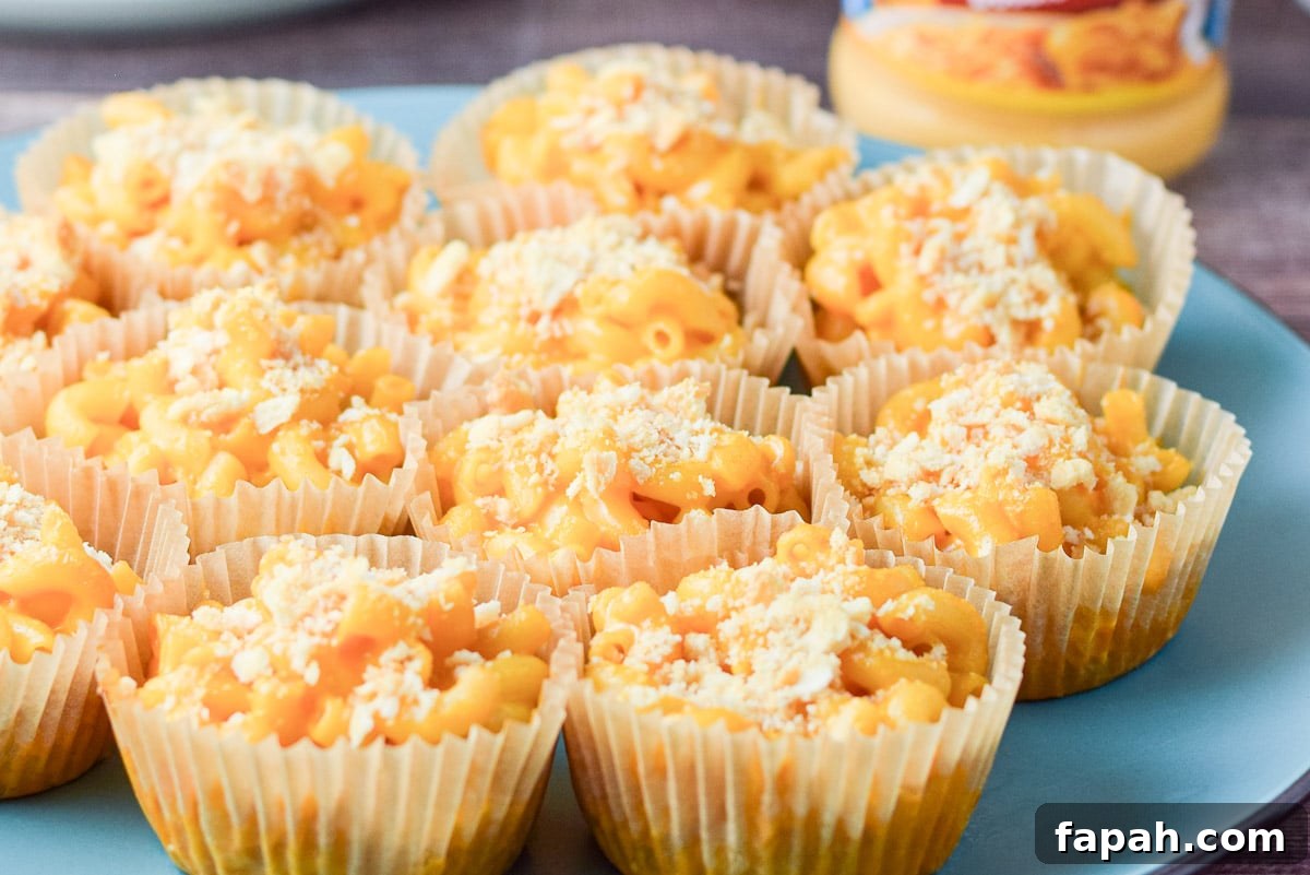 Blue plate with muffin cups of mac and cheese in them