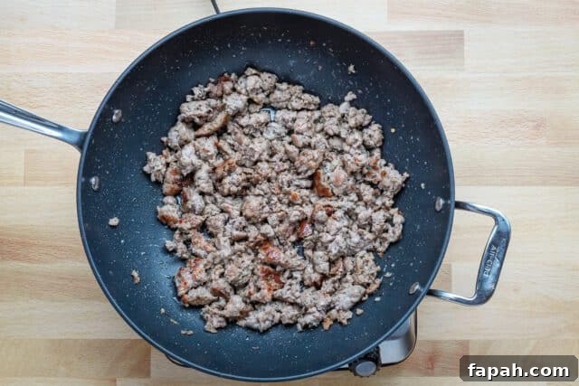 Savory Sausage and Brioche Stuffing Recipe 5 Browning sausage for a brioche stuffing recipe.