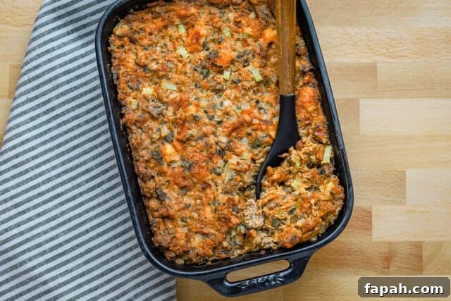 Savory Sausage and Brioche Stuffing Recipe 9 Brioche stuffing in a baking dish with sausage, herbs, and aromatics.