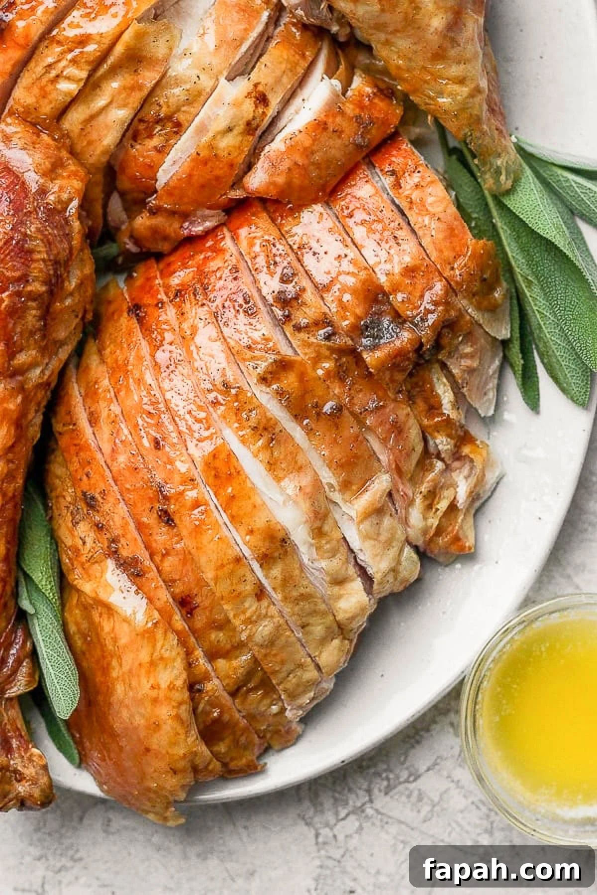 Close up of a sliced smoked turkey breast on a platter.