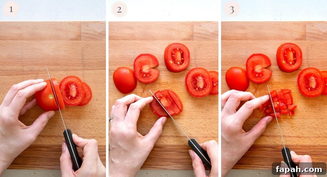 Israeli Salad a tomato being chopped into fine cubes to make Israeli Salad