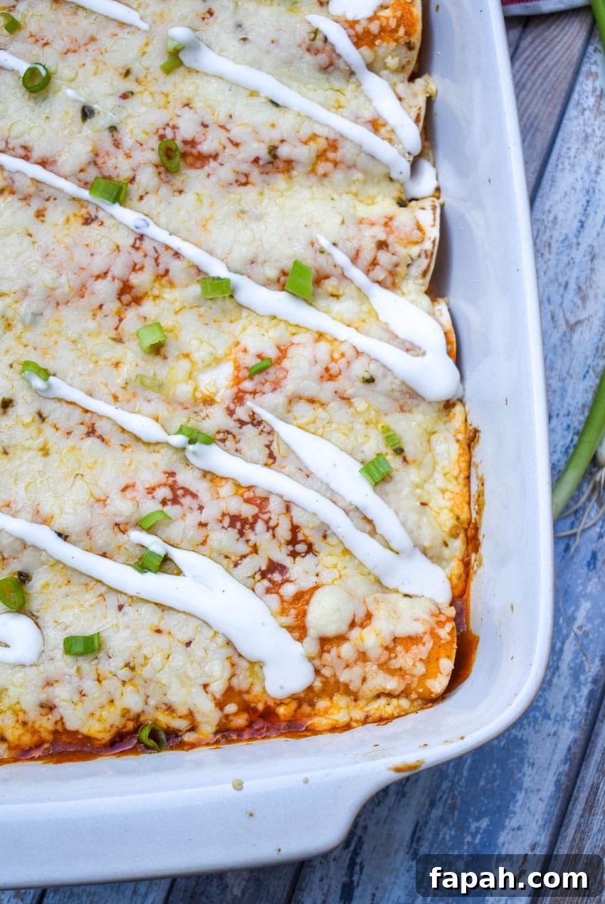 buffalo chicken enchiladas in a white baking dish