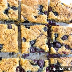 Chewy Blueberry Blondies with Lemon Glaze 17 blueberry blondies recipe cut into bars on cutting board