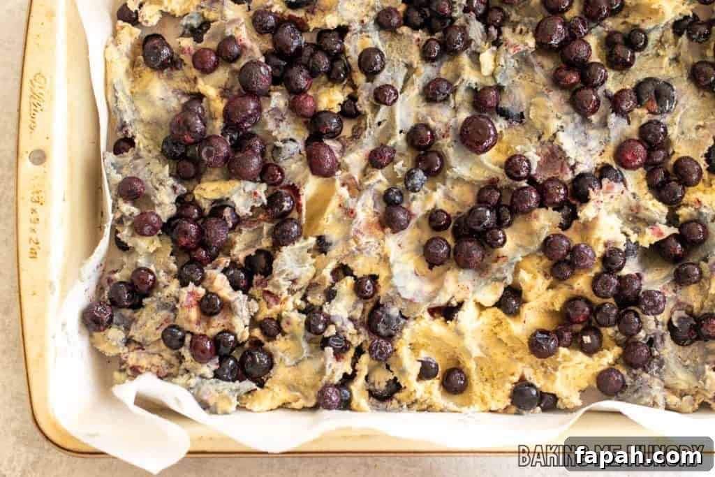 Chewy Blueberry Blondies with Lemon Glaze 9 blueberries added on top of batter
