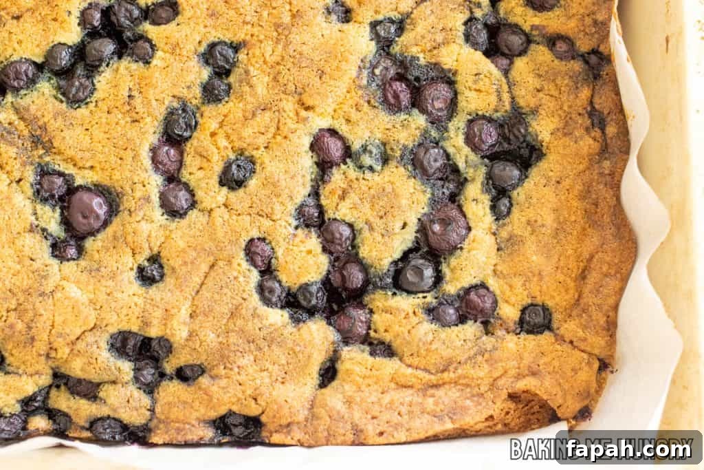 Chewy Blueberry Blondies with Lemon Glaze 10 baked bars in parchment lined pan
