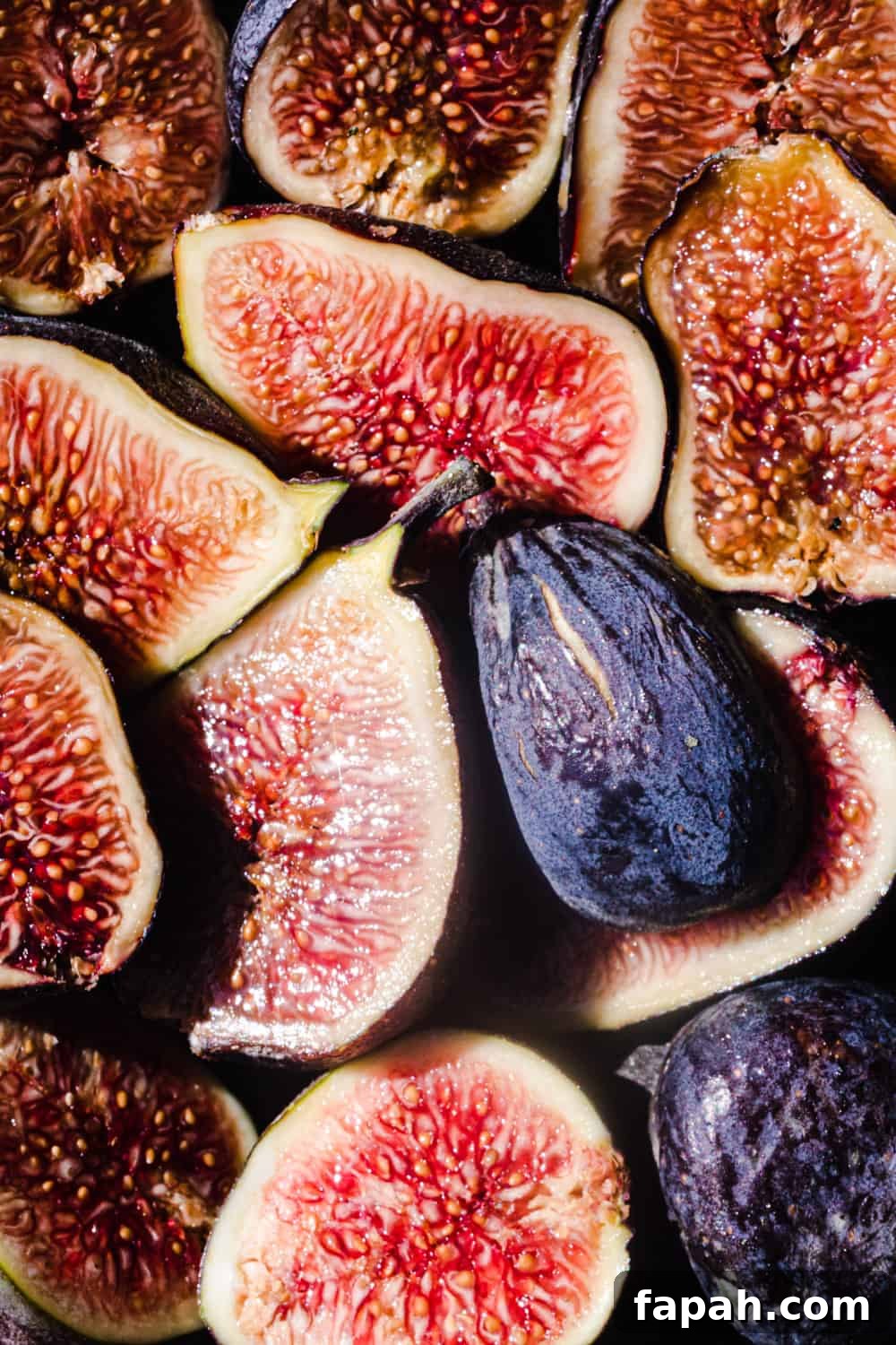 Up close shot of fresh, raw figs cut in half, you can really see the texture of the figs inside; overhead shot.