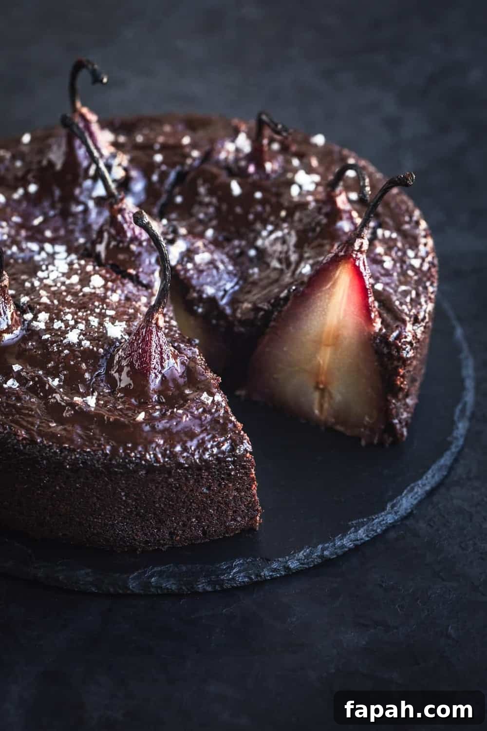 Red wine-poached pears in chocolate cake, topped with ganache and sea salt.
