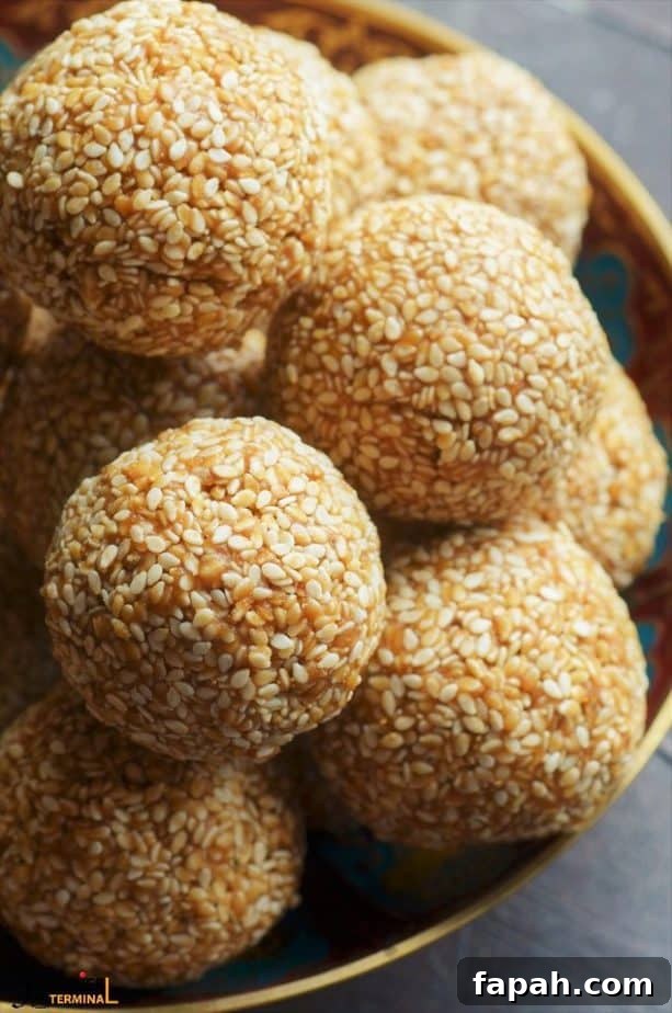 Sesame Ladoo Recipe: Traditional Til Laddu for Festivals 3 soft til gud laddu stacked in a pile