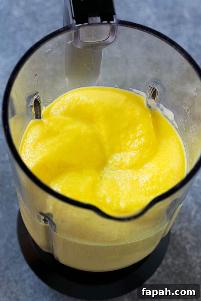 A blender full of pineapple smoothie.