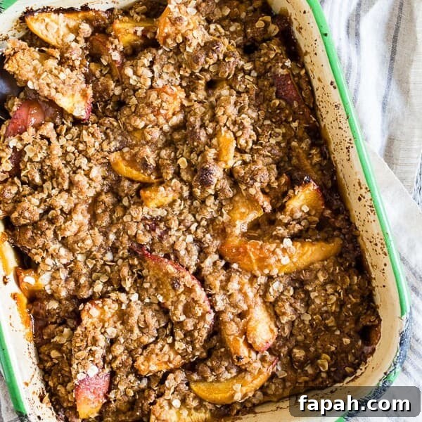 Cardamom Vanilla Plum Crisp with Almond Oat Streusel 6 ginger peach crisp in a small metal dish