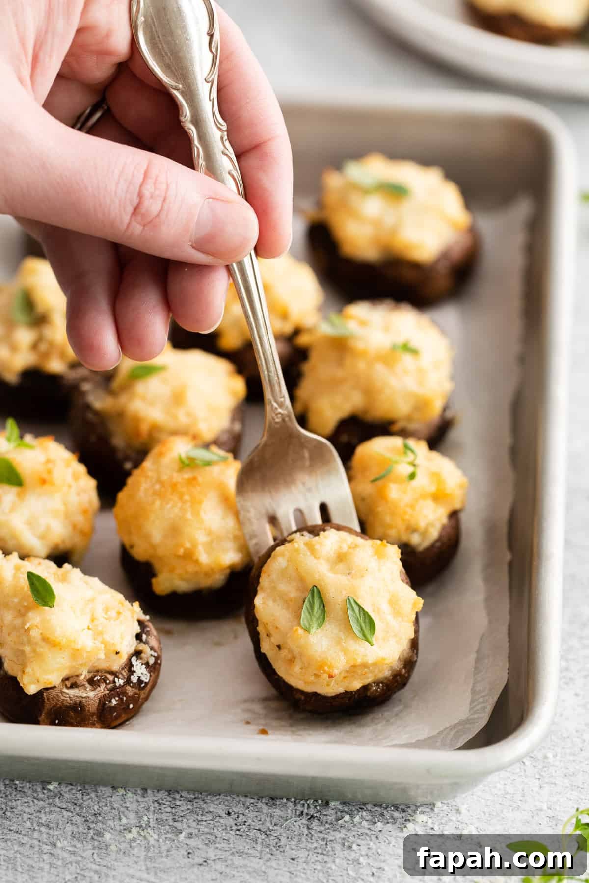 Crab stuffed mushroom on a fork.