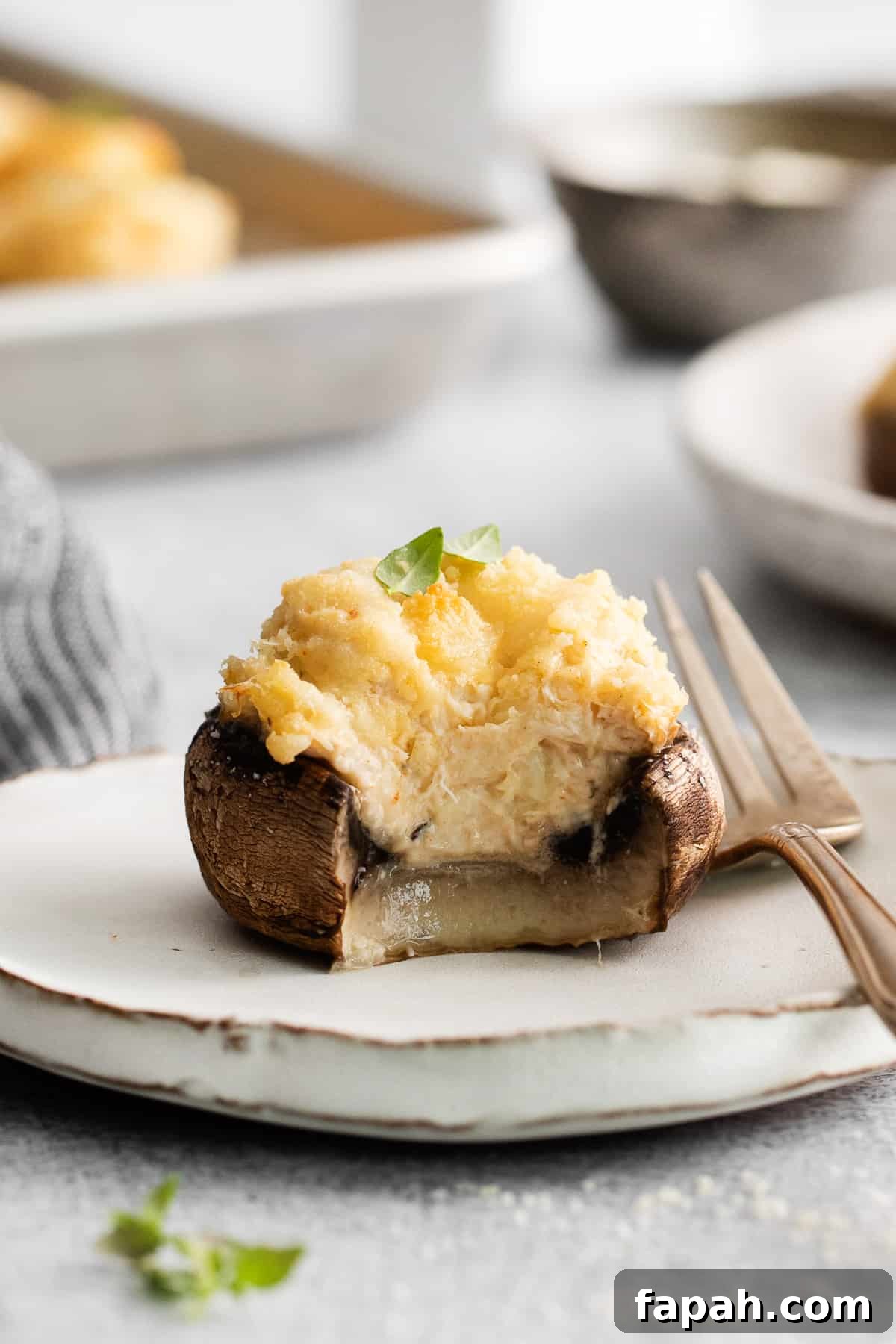 Crab stuffed mushroom with a bite taken out of it.
