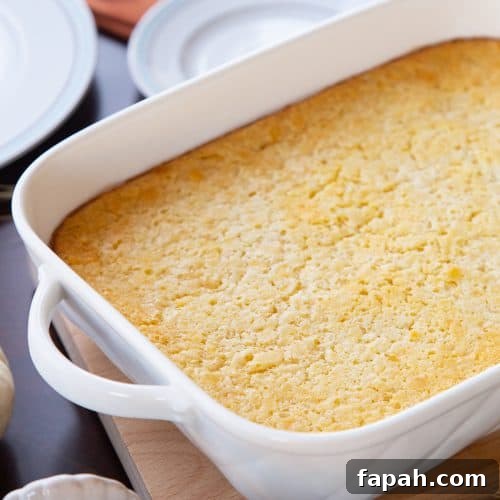 corn casserole in a white casserole dish.