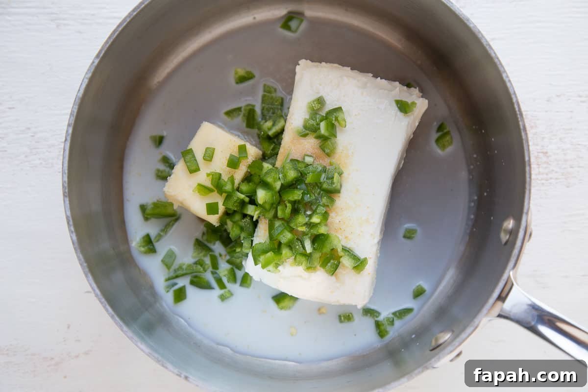 cream cheese, butter, and jalapeno in a saucepan.