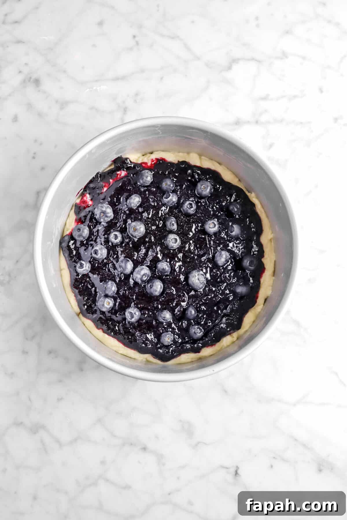 Blueberry jam and blueberries added on top of cake batter
