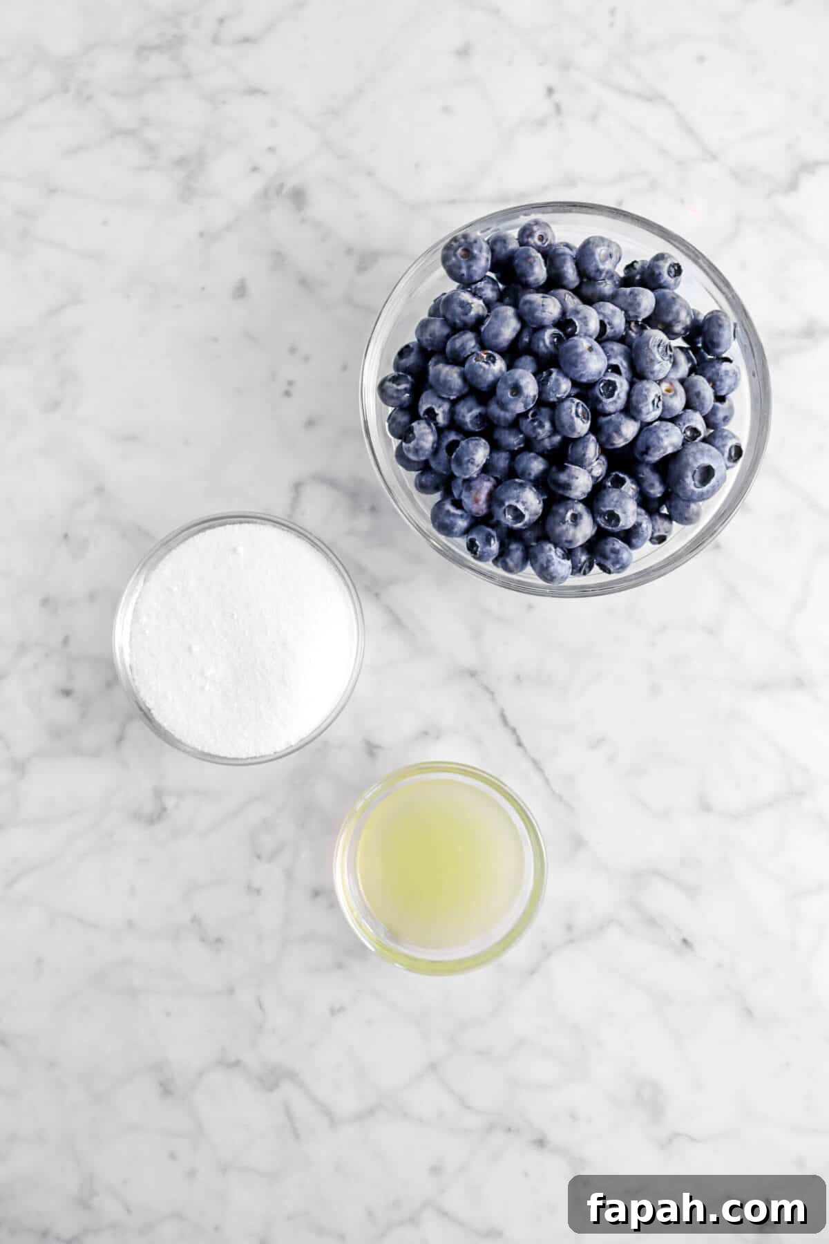 blueberries, sugar, and lemon juice in bowls