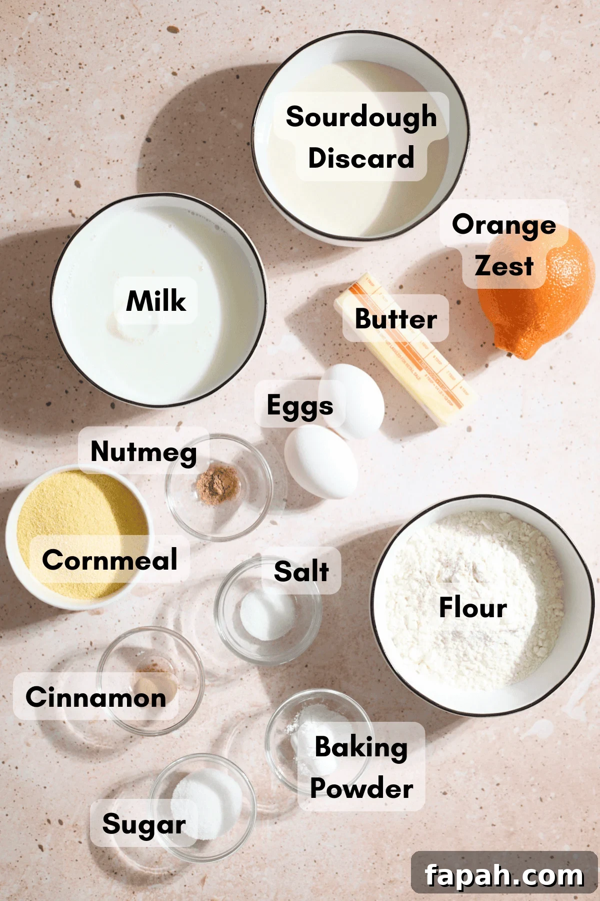 Ingredients for Sourdough Cornmeal Waffles in small bowls.