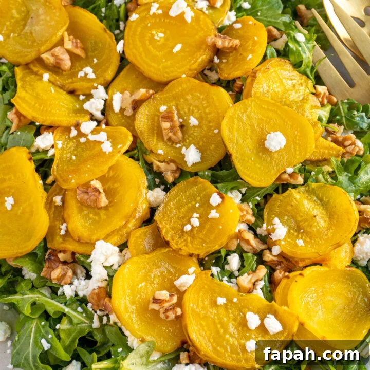 A platter of arugula topped with golden beets, walnuts, and feta cheese.