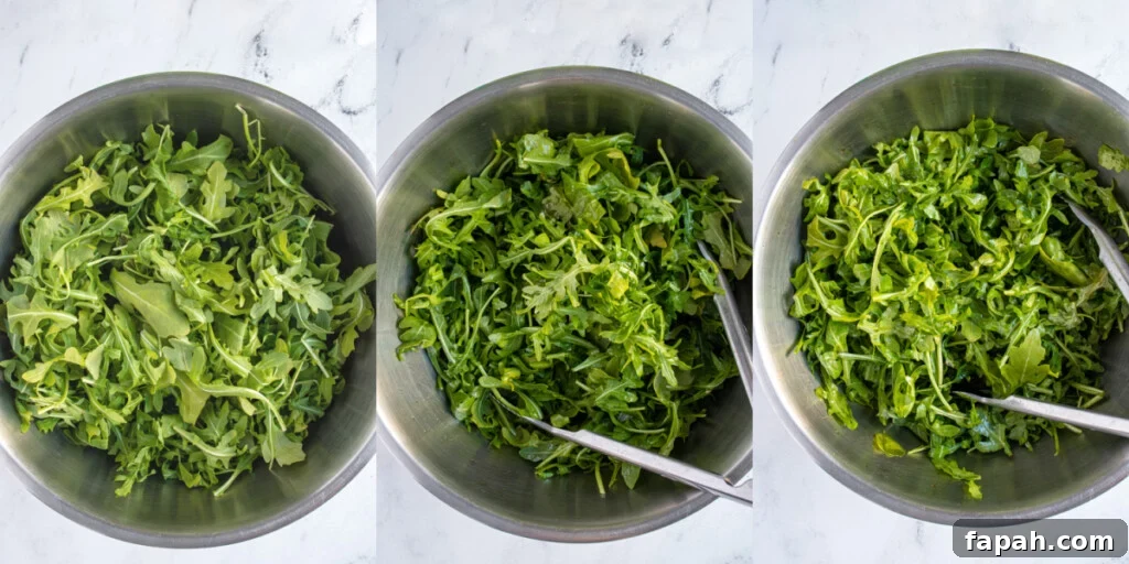 Arugula & Roasted Golden Beet Salad with Citrus Vinaigrette 6 Dressing arugula in a bowl with tongs.