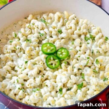 Creamy Jalapeño Ranch Pasta Recipe for a Flavorful Weeknight Meal 15 Creamy jalapeño ranch pasta topped with sliced jalapeños and cilantro in a large pot.