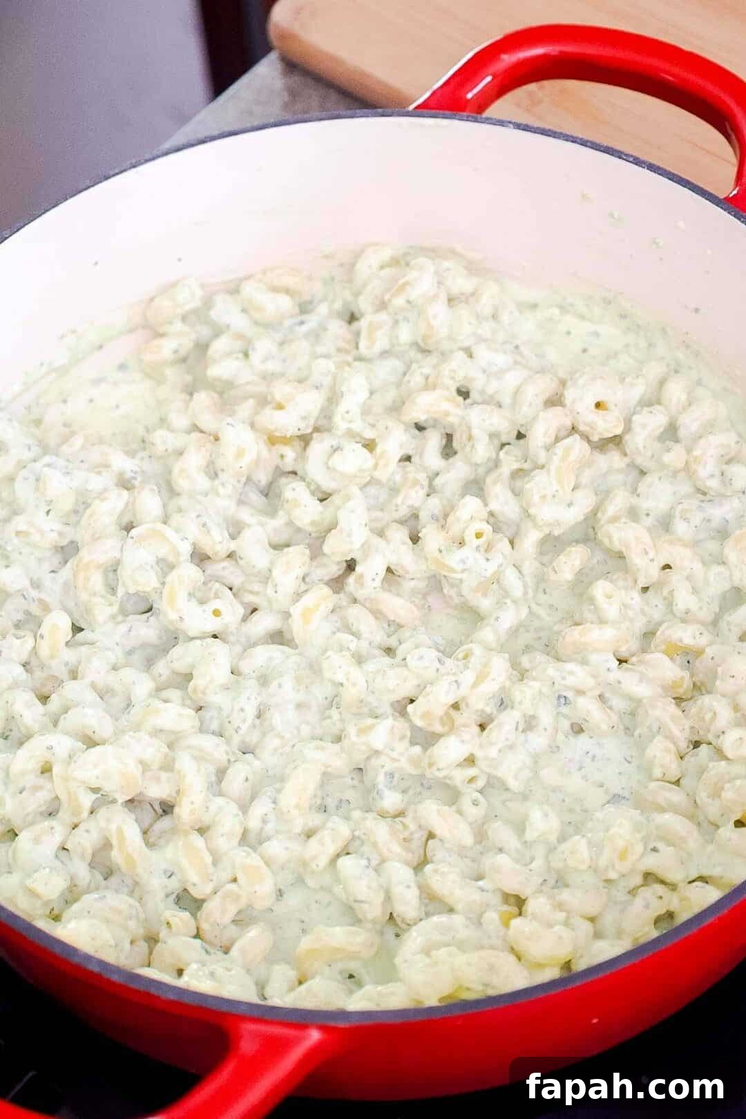 Creamy Jalapeño Ranch Pasta Recipe for a Flavorful Weeknight Meal 9 Pasta stirred into creamy jalapeño ranch sauce in a large pot.