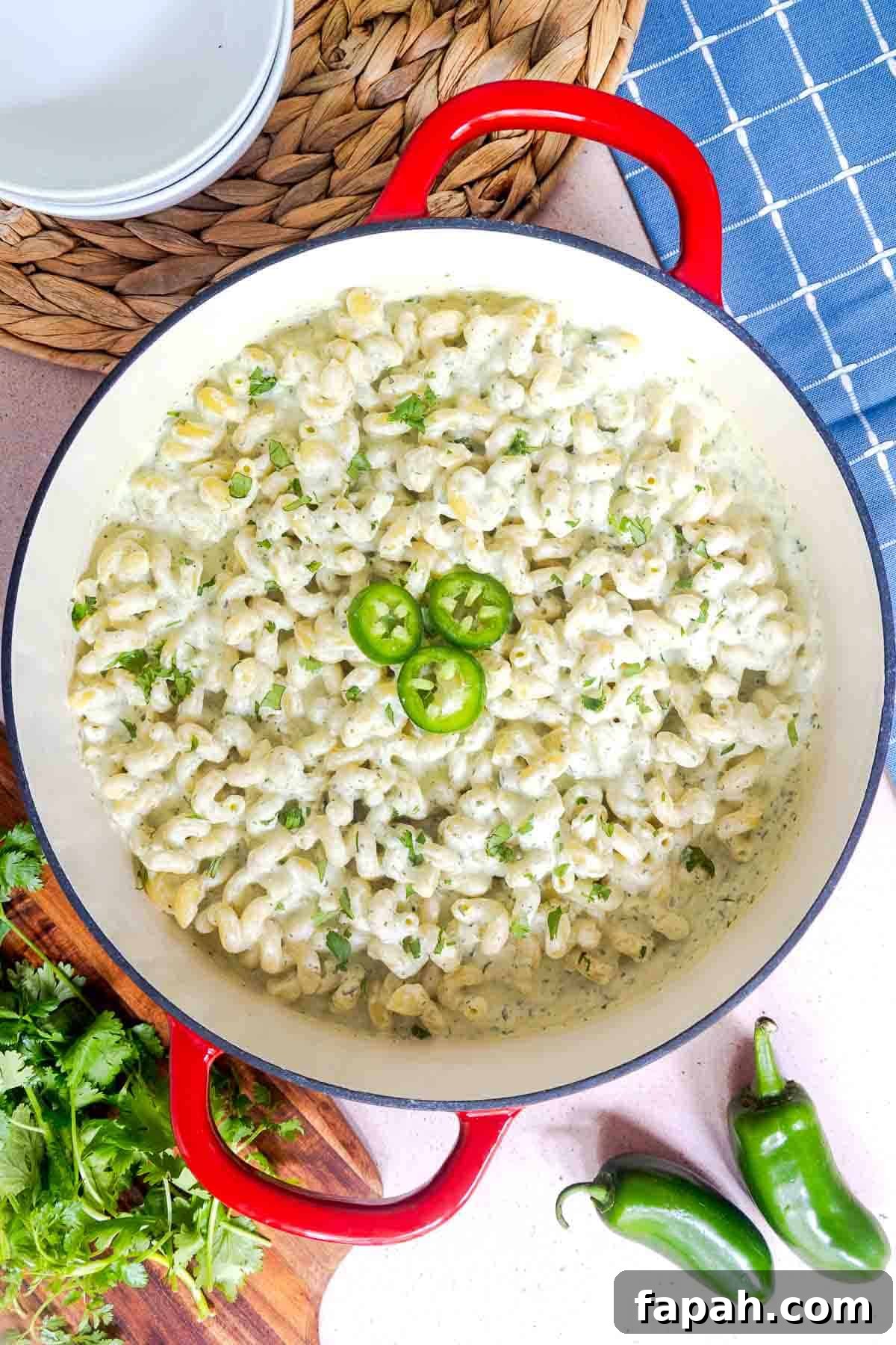 Creamy Jalapeño Ranch Pasta Recipe for a Flavorful Weeknight Meal 10 Cooked jalapeño pasta in a pot coated in a creamy sauce, topped with sliced jalapeños and cilantro.