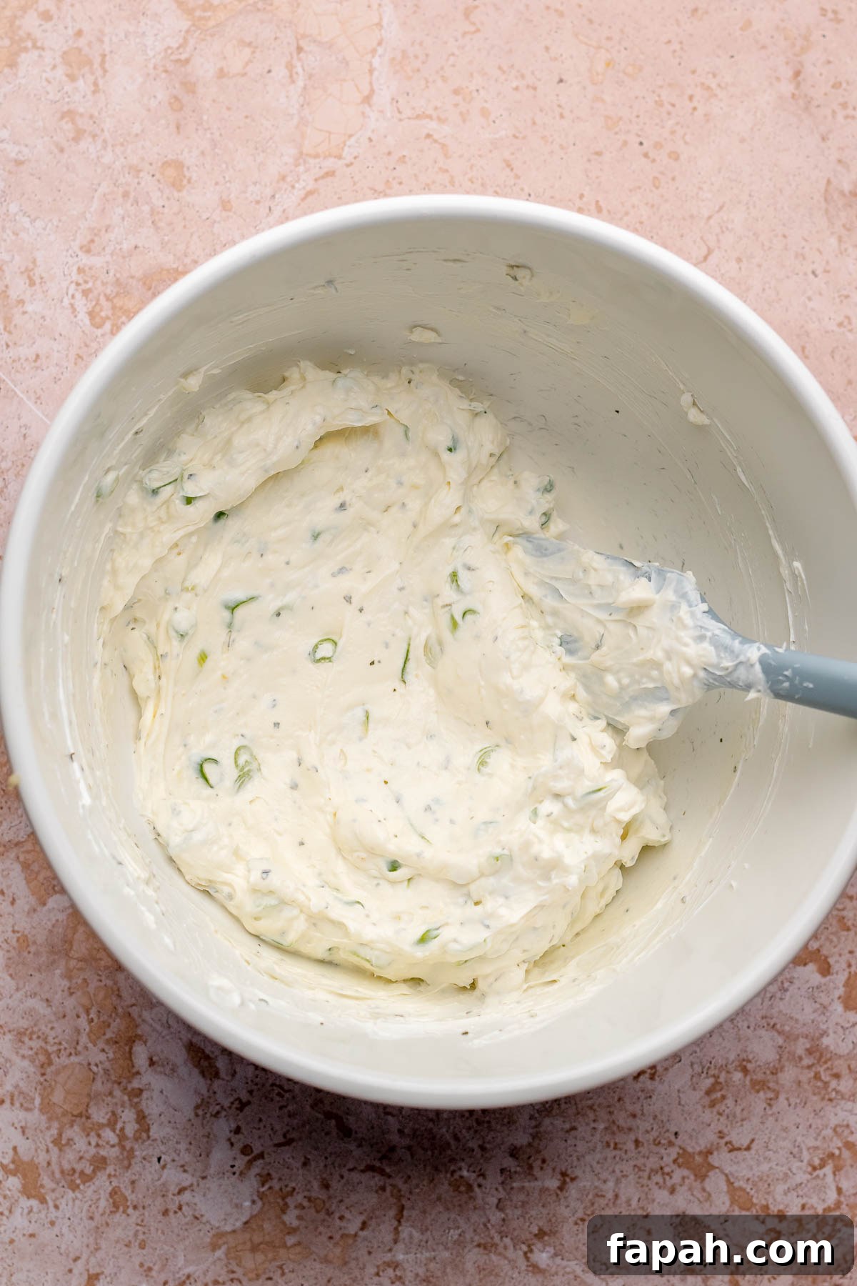 Cheesy Chicken Bacon Ranch Dip — Oven or Crockpot Recipe 4 Cream cheese and seasonings mixed in a bowl.
