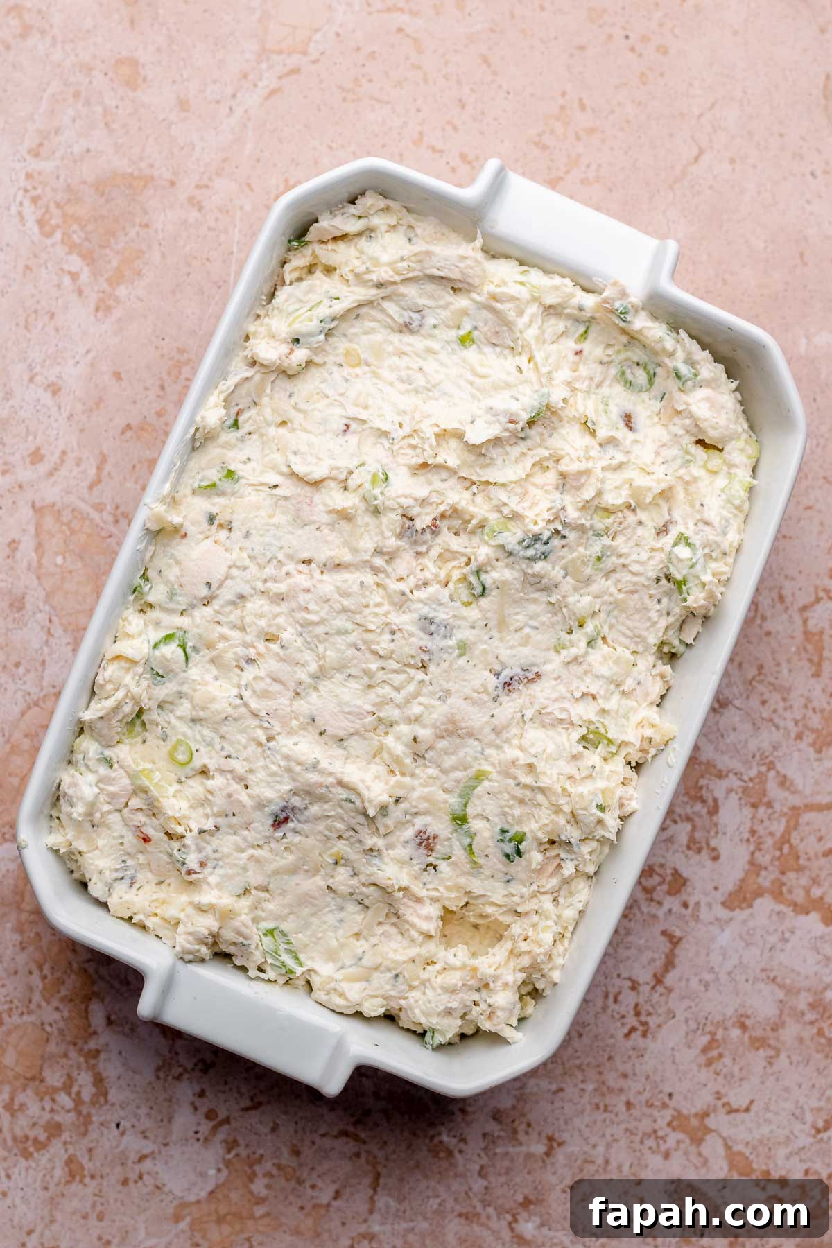 Cheesy Chicken Bacon Ranch Dip — Oven or Crockpot Recipe 6 Chicken bacon ranch dip in a casserole dish before baking.