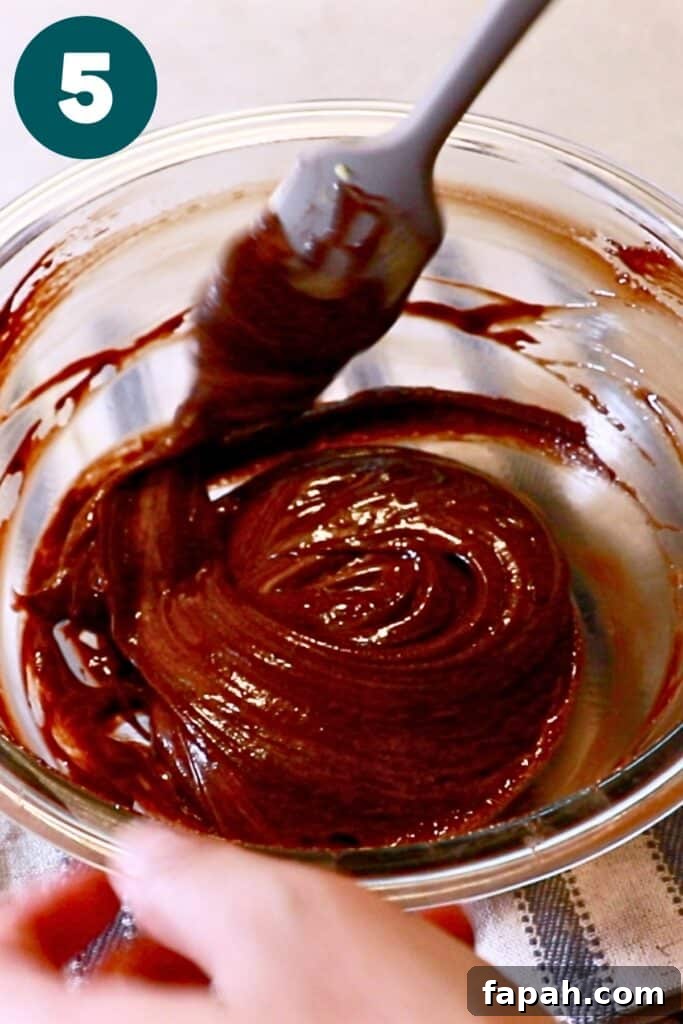 Decadent Chocolate Mousse Recipe for Silky, Airy Dessert 12 combined pate au bombe into melted chocolate