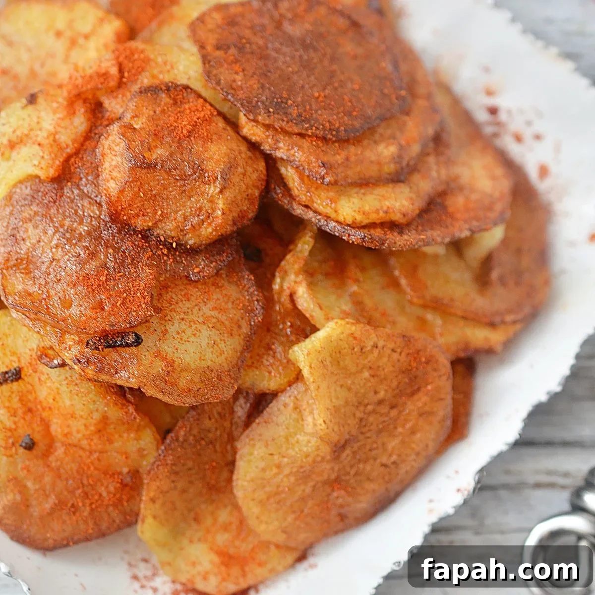 Looking closely at some fried potato crisps and fried onions.