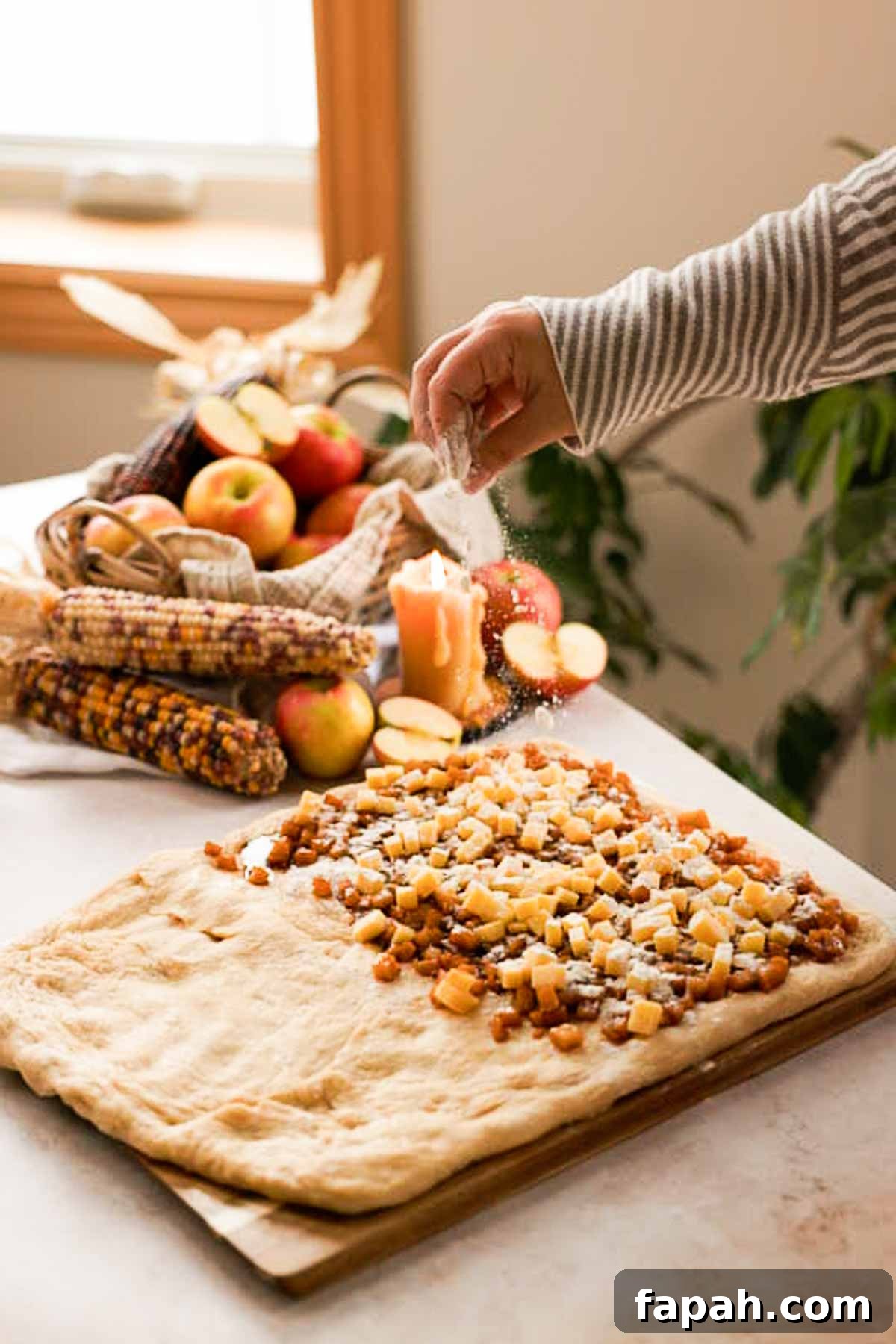 sprinkling apple filling and cheese with flour
