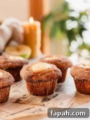 apple cider muffins arranged on parchment paper