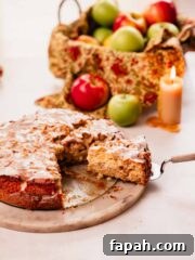 slice of apple fritter cake with vanilla glaze on a cake spatula